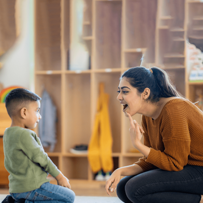 mother teaching her kid to speak