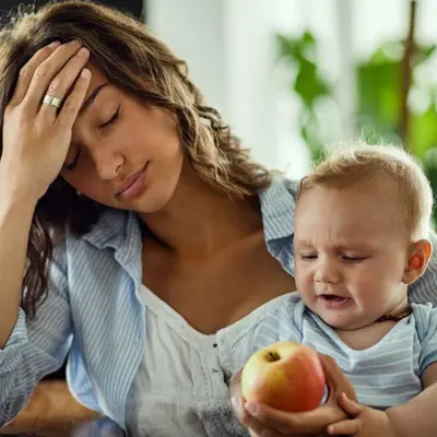 mom holding child, experiencing postpartum depression mom holding child, experiencing postpartum depression